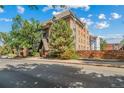 Brick condo building exterior with lush trees and Tudor-style architectural details at 1350 Josephine St # 508, Denver, CO 80206