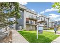 Modern three-story townhome with attached garage and landscaped lawn at 1615 Julian St # 102, Denver, CO 80204