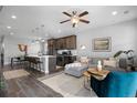 Open concept living area with L-shaped sectional sofa at 25146 E 1St Ave, Aurora, CO 80018