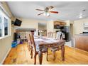 Dining room features a large table, ceiling fan, and access to the kitchen at 7751 Niagara St, Commerce City, CO 80022