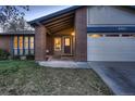 Charming brick home with well-maintained lawn and a covered front entrance, perfect for a welcoming first impression at 8965 Jellison Ct, Broomfield, CO 80021