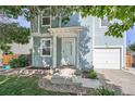 Inviting front entrance with a covered porch and well-maintained landscaping and blue siding at 1272 Bluebird St, Brighton, CO 80601