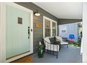 Inviting front porch with seating area, light-blue door, and house number displayed at 1738 S Franklin St, Denver, CO 80210