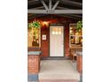 Welcoming front porch with seating and vibrant hanging plants enhancing curb appeal at 4150 Raritan St, Denver, CO 80211