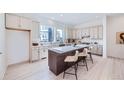 Spacious kitchen featuring an island, sleek countertops, and modern appliances at 664 Saddle Dr, Erie, CO 80516