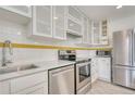 Well-equipped kitchen with stainless steel appliances, white cabinetry, and ample counter space at 2152 Grant St, Longmont, CO 80501