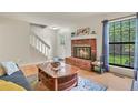 Cozy living room featuring a brick fireplace, hardwood floors, and natural light at 10310 E Jewell Ave # 55, Aurora, CO 80247