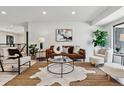 Spacious and stylish living room featuring modern furniture, white floors, and ample natural light at 2427 S Eldridge Ct, Lakewood, CO 80228