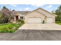 Inviting exterior with a spacious driveway and a two-car garage, complemented by beautiful landscaping at 1590 Longview Cir, Monument, CO 80132