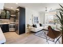 Bright living room and kitchen featuring a modern design, sleek appliances, and stylish furniture at 1922 E 18Th Ave, Denver, CO 80206