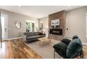 Comfortable living room featuring a modern fireplace, hardwood floors, stylish furnishings, and an inviting atmosphere at 3126 Perry St, Denver, CO 80212