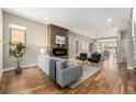 Bright living room featuring a modern fireplace, hardwood floors, stylish furnishings, and an open layout at 3126 Perry St, Denver, CO 80212