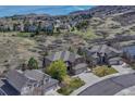 A beautiful neighborhood of houses that backs onto a mountain landscape with clear streets and driveways at 580 Eagle Nest Ct, Golden, CO 80401