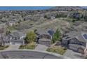 An aerial view of beautiful single Gathering homes complete with well-manicured lawns and neighborhood streets at 580 Eagle Nest Ct, Golden, CO 80401