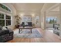Bright living room featuring large windows, hardwood floors, and a comfortable seating area at 580 Eagle Nest Ct, Golden, CO 80401