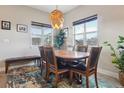 Bright dining room with modern lighting and bench seating by the windows at 6760 Meade Cir # C, Westminster, CO 80030