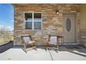 Inviting porch with stone facade, cozy seating, and a well-lit entryway at 6760 Meade Cir # C, Westminster, CO 80030