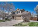 Attractive two-story home with a three-car garage, showcasing a well-maintained front yard at 18655 E Garden Pl, Aurora, CO 80015