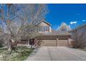 Charming two-story home featuring a spacious three-car garage and welcoming front porch at 18655 E Garden Pl, Aurora, CO 80015