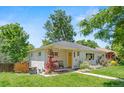 Beautiful front exterior with a well-maintained lawn and a cozy seating area by the front door at 3177 S Grant St, Englewood, CO 80113