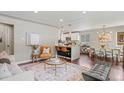 Bright, open-concept living room featuring modern decor, hardwood floors, and seamless flow to the kitchen at 3177 S Grant St, Englewood, CO 80113