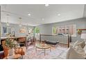 Bright living room with hardwood floors, modern decor, open to kitchen, and lots of light from windows at 3177 S Grant St, Englewood, CO 80113