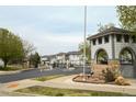 Community entrance with a stone monument, gate, and well-maintained landscaping at 3281 E 103Rd Pl # 1403, Thornton, CO 80229