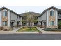 Two-story condo building with stone and siding exterior with well-kept landscaping at 3281 E 103Rd Pl # 1403, Thornton, CO 80229