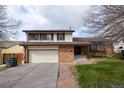 Charming two-story home featuring a brick facade, attached garage and a well-maintained front yard at 530 S Laredo Cir, Aurora, CO 80017