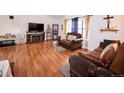 Spacious living room with hardwood floors, fireplace, entertainment center, and comfortable sofas at 530 S Laredo Cir, Aurora, CO 80017