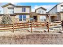 Beautiful townhome facade with stone accents, a well-manicured lawn, and a charming wooden fence at 726 Vista Verde Hts, Monument, CO 80132