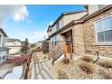 Well-maintained home exterior with stone accents, complemented by a landscaped yard and a welcoming entrance at 726 Vista Verde Hts, Monument, CO 80132