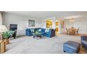 Comfortable living room with ample seating, open layout, and access to both the kitchen and dining area at 13631 E Marina Dr # 201, Aurora, CO 80014