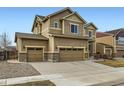 Attractive home with a three-car garage, complemented by well-kept landscaping at 10057 Granby St, Commerce City, CO 80022