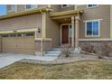 Welcoming front entrance with a charming porch and meticulously landscaped yard at 10057 Granby St, Commerce City, CO 80022