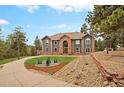 Beautiful exterior elevation showcasing the home's architectural details and landscaped front yard at 24140 Us Highway 40, Golden, CO 80401