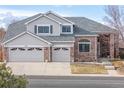 A charming two-story home with a brick facade and a two-car garage located in a quiet neighborhood at 18981 E Belleview Pl, Centennial, CO 80015