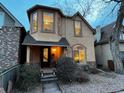 Charming two-story home boasting a unique architectural design with a quaint front porch, and mature landscaping at 2636 W 27Th Ave, Denver, CO 80211