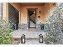 Welcoming front porch with stone accents, a decorative door, and ambient lighting. A great entry to the home at 2636 W 27Th Ave, Denver, CO 80211