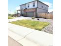 Charming two-story house featuring a well-maintained lawn, covered porch, and two car garage at 13315 Xanthia St, Thornton, CO 80602