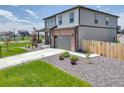 Well-maintained home showcases a spacious driveway, a front porch, and professional landscaping at 13315 Xanthia St, Thornton, CO 80602