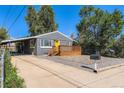 Street view of a cozy home with a new wooden porch and carport in a quiet neighborhood at 695 S Quitman St, Denver, CO 80219