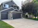 Charming two-story home featuring a spacious two-car garage, well-manicured lawn and mature trees at 10330 Lions Path, Lone Tree, CO 80124
