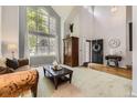 Bright living room with soaring ceilings, large windows, and neutral decor at 10330 Lions Path, Lone Tree, CO 80124