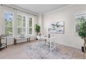 Bright home office featuring a modern desk, large windows, and stylish decor at 3529 Xanthia Ct, Denver, CO 80238