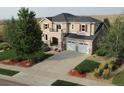 Attractive two-story home with a two-car garage, lush landscaping, and a spacious driveway at 4939 Silver Feather Cir, Broomfield, CO 80023