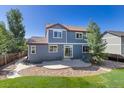 Serene backyard featuring a lovely stone patio and lush greenery, perfect for outdoor relaxation at 11957 S Swift Fox Way, Parker, CO 80134