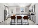 Modern kitchen boasts granite countertops, stainless steel appliances, and a convenient breakfast bar for casual dining at 56582 E 23Rd Ave, Strasburg, CO 80136