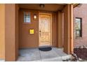 Close-up of a wooden front door with a small window and house number displayed above at 3394 W 33Rd Ave, Denver, CO 80211