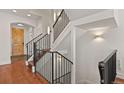 Modern staircase with iron railings, white walls, and sconce lighting at 3394 W 33Rd Ave, Denver, CO 80211